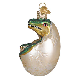 Baby dino in egg ornament featuring a green and gold glass t-rex dinosaur ornament lighted figural decor