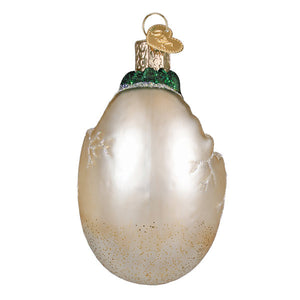 Baby dino in egg ornament is a pearlescent white glass t-rex dinosaur ornament with green glittery top and silver snowflakes