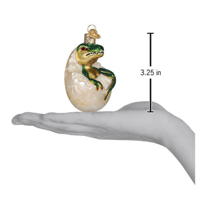 Baby dino in egg ornament featuring a green and gold glass t-rex dinosaur ornament as figural decor and lighted decor