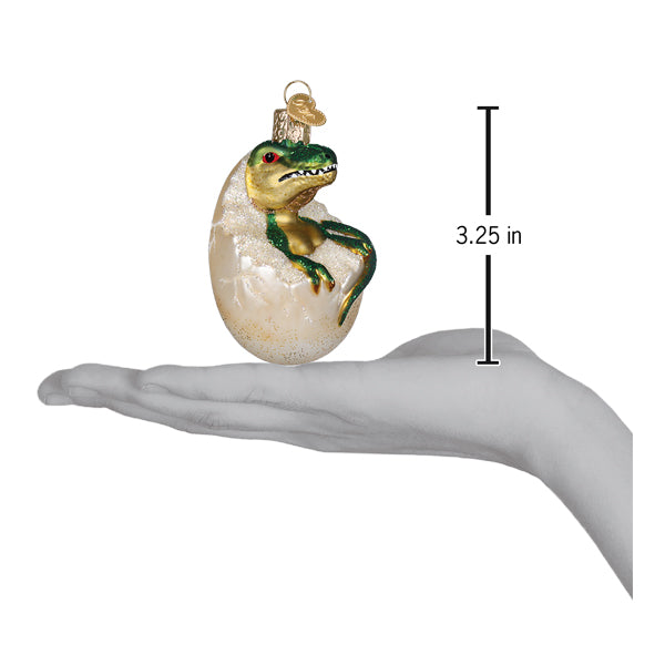 Baby dino in egg ornament featuring a green and gold glass t-rex dinosaur ornament as figural decor and lighted decor