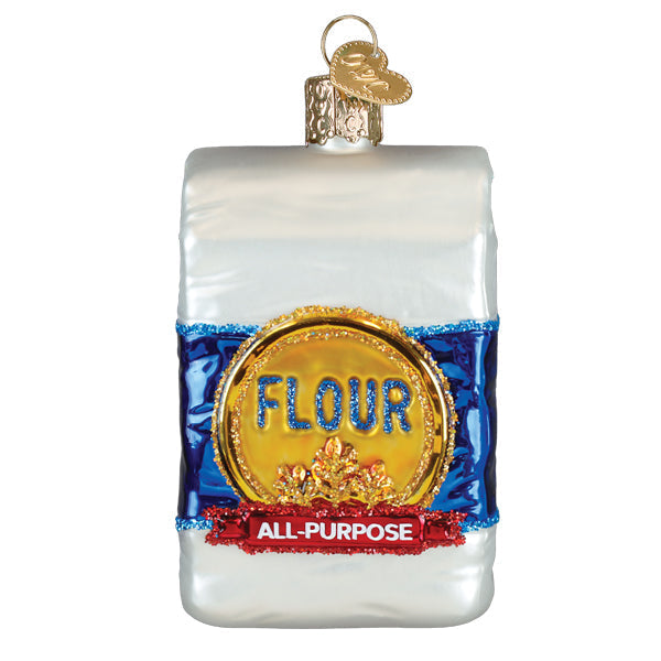 A clear glass bag of flour ornament with blue and red glittery accents and gold lettering, perfect figural decor