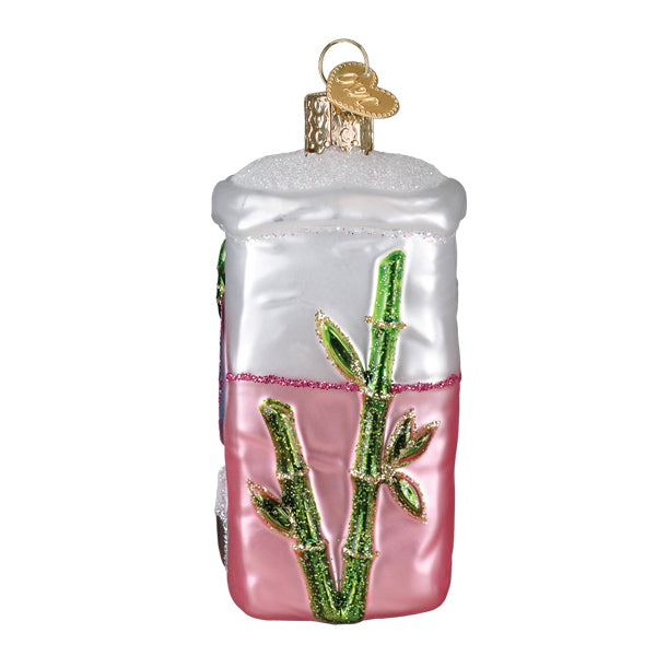 Bag of sugar ornament shaped like translucent glass soy sauce ornament with white top pink bottom and glittery green bamboo stalks