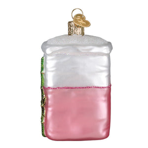 Pink and white glass bag of sugar ornament shaped like a layered cake with green icing figural decor for lighted decor