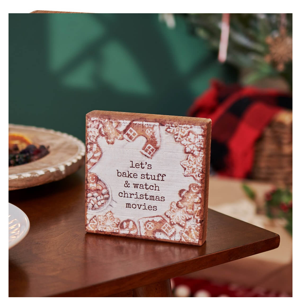 A rustic wooden bake stuff block sign by michele kixmiller design with christmas movie text and gingerbread patterns