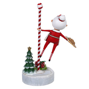 Baking spirits bright candy cane pole with a red elf figure holding cookies perfect for a childs christmas figures display