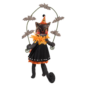 Black cat girl figurine in orange party hat and black dress with yellow collar featuring bat juggling design