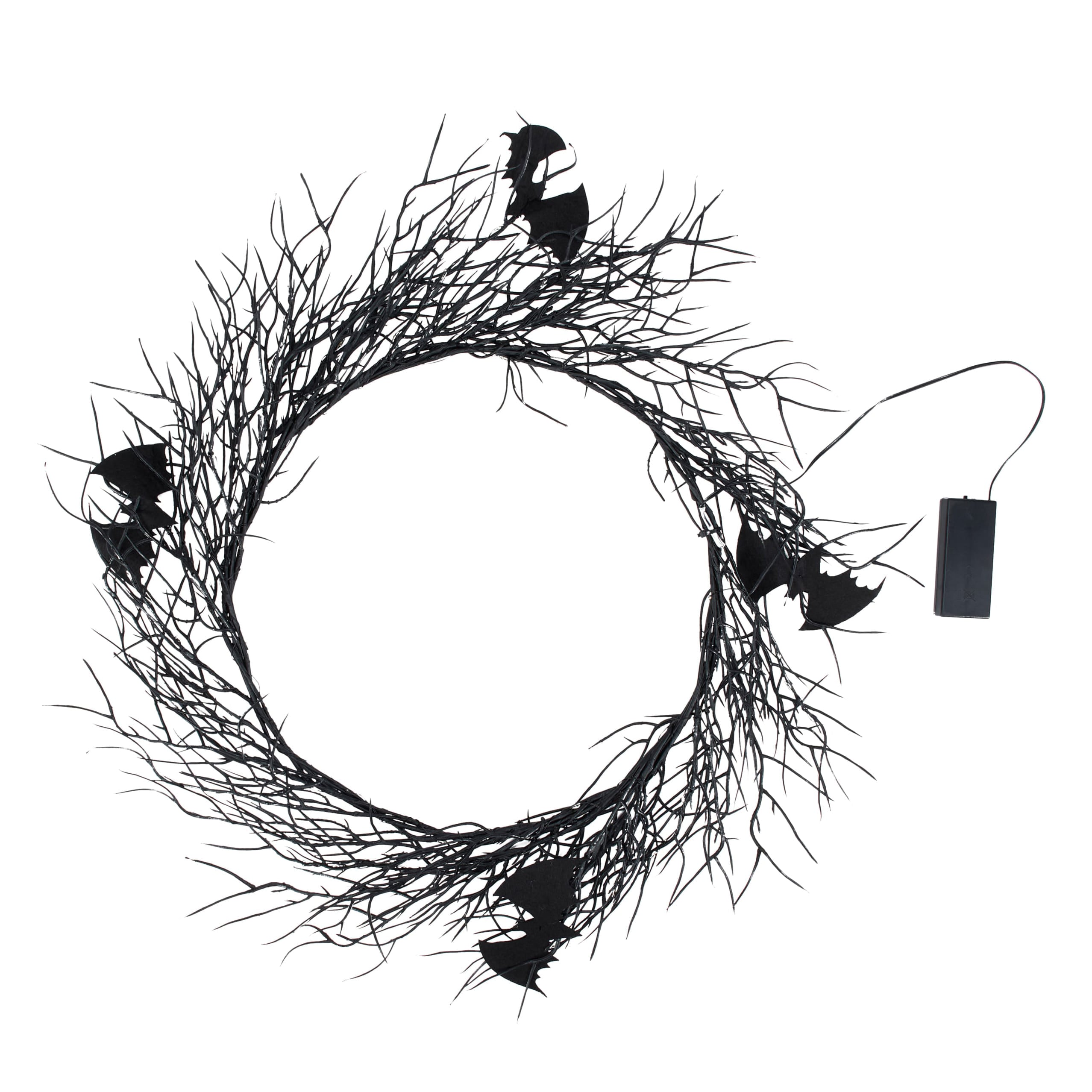 Black halloween wreath made of twisted branches with bat cutouts perfect for vintage easter and spring hanging decor