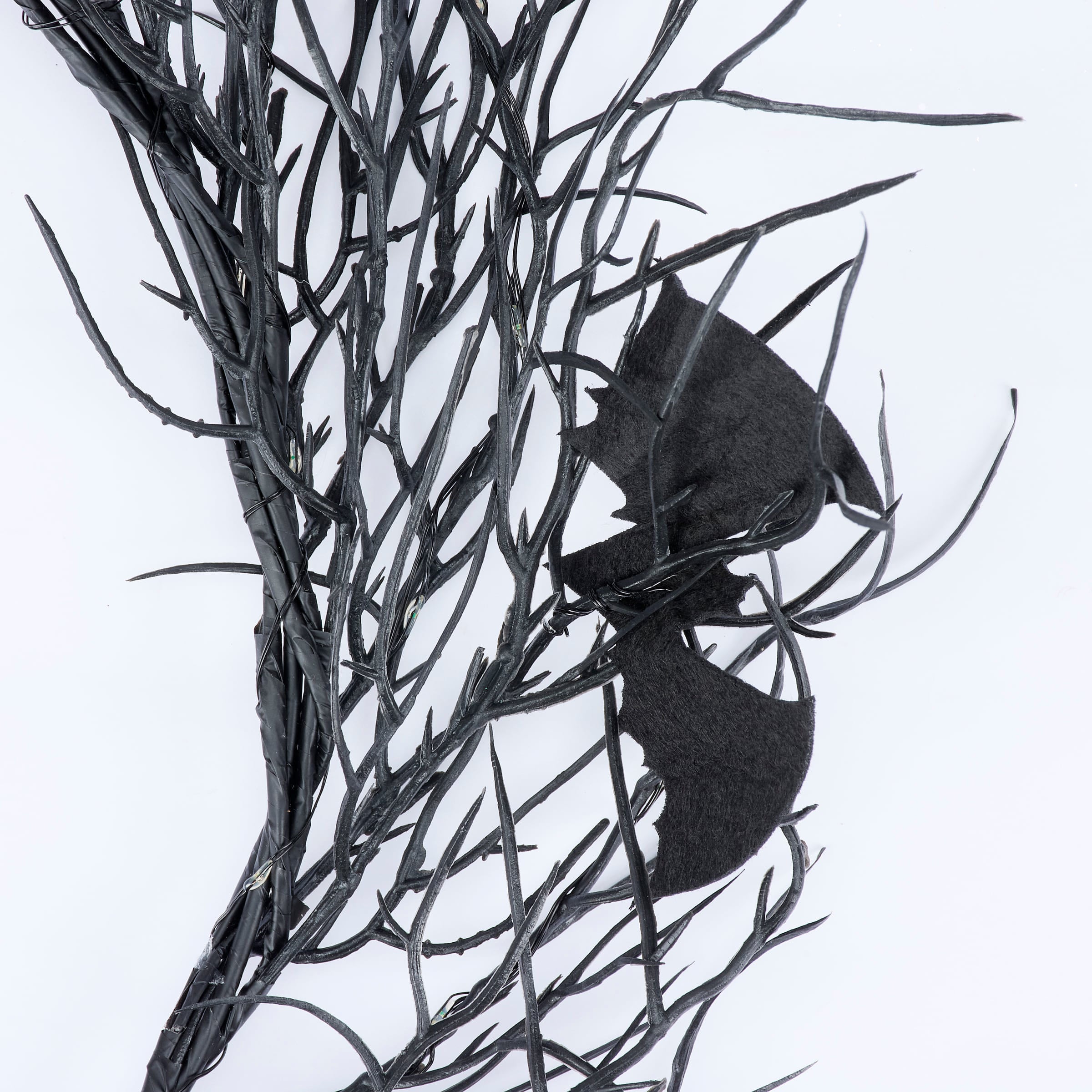 Black faux leather bat perched on dark twig branches in batty lighted wreath for vintage easter and spring hanging wall decor