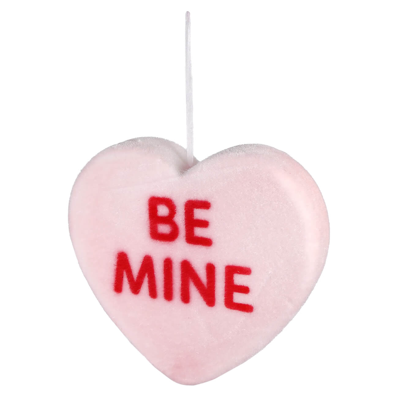 Pink heart-shaped candy with ’BE MINE’ written in red letters.