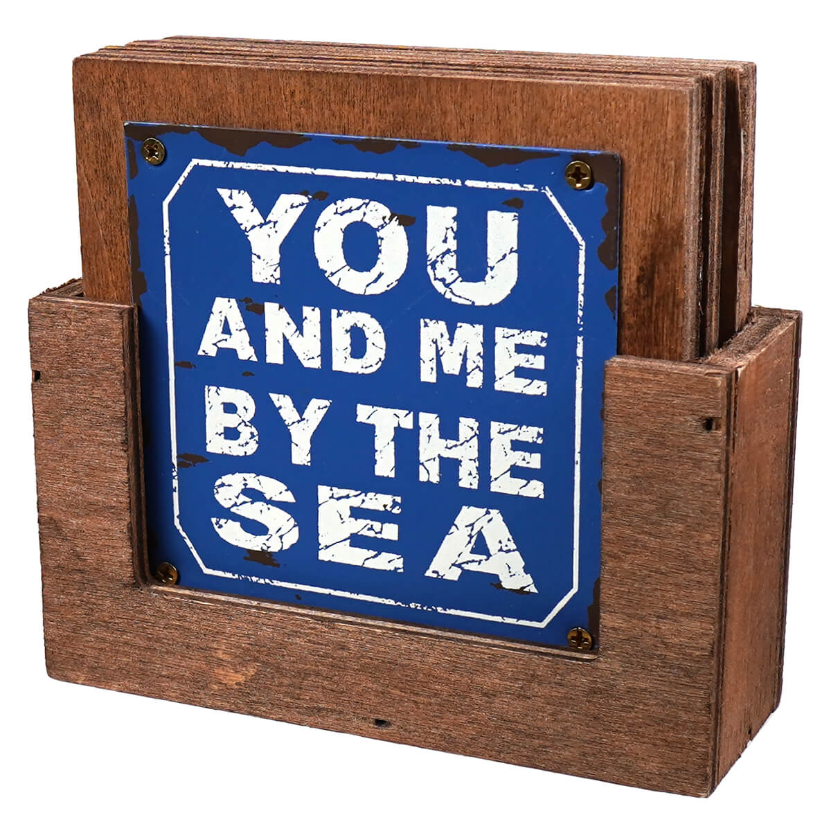 Blue distressed metal sign with white cracked lettering reading you and me by the sea on rustic wooden coaster holder in beachcombers wood metal plated beach sayings coasters set with johanna parker figural decor