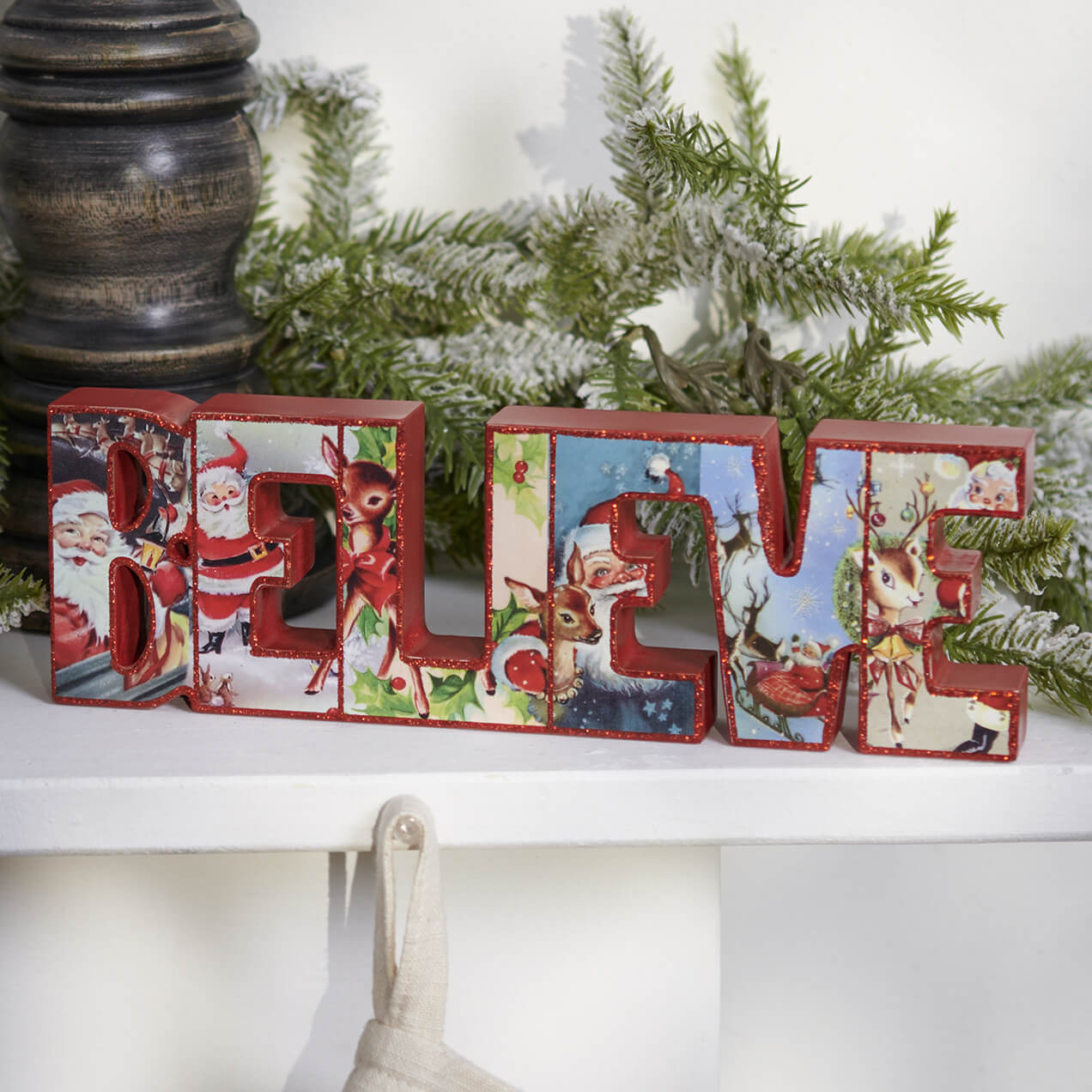 Decorative Christmas blocks spelling out ’BELIEVE’ with vintage Santa and reindeer illustrations.