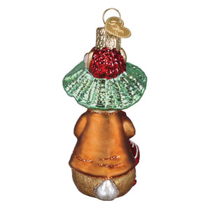 A glass christmas ornament featuring a whimsical rabbit in an orange coat with gold glitter trim, wearing a green ruffled collar and holding a red sparkly berry.