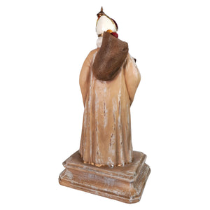 Antique-style resin statue of st nicholas in beige robe with gold accents carrying sack by bethany lowe designs santa figures