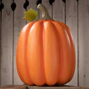 Big mouth jack o lantern vibrant orange halloween pumpkin made of painted resin with green stem and leaf