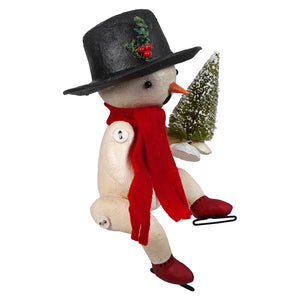 A charming cream-colored snowman figurine from bethany lowe designs bing wearing a red scarf and holding a frosted pine tree
