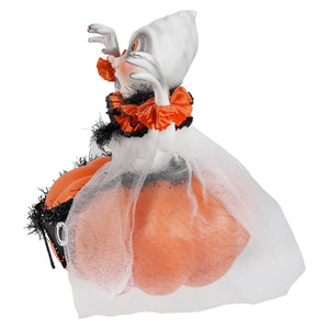 A binx boo ghost figurine in white with orange eyes and black orange ruffled collar on a pumpkin base with tulle ghost decor