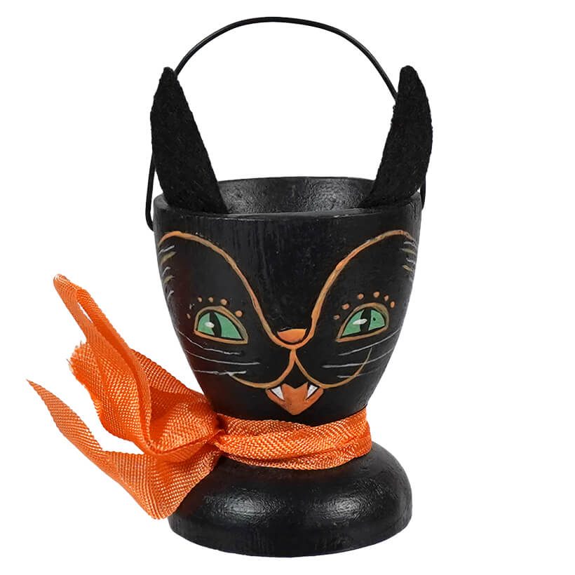 Black cat-shaped Halloween candy bucket with pointed ears and an orange scarf.