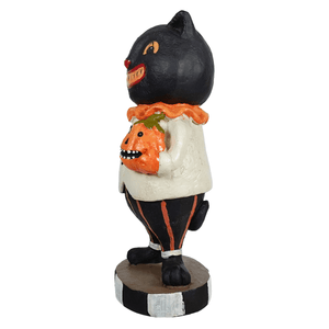 Black cat holding jack-o-lantern figurine with orange pumpkin wearing white shirt and black striped pants for halloween figural decor