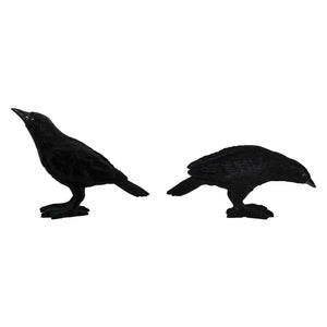 Two matte black velvet flocked crows figurines set with one standing alert and one crouching for spooky decor