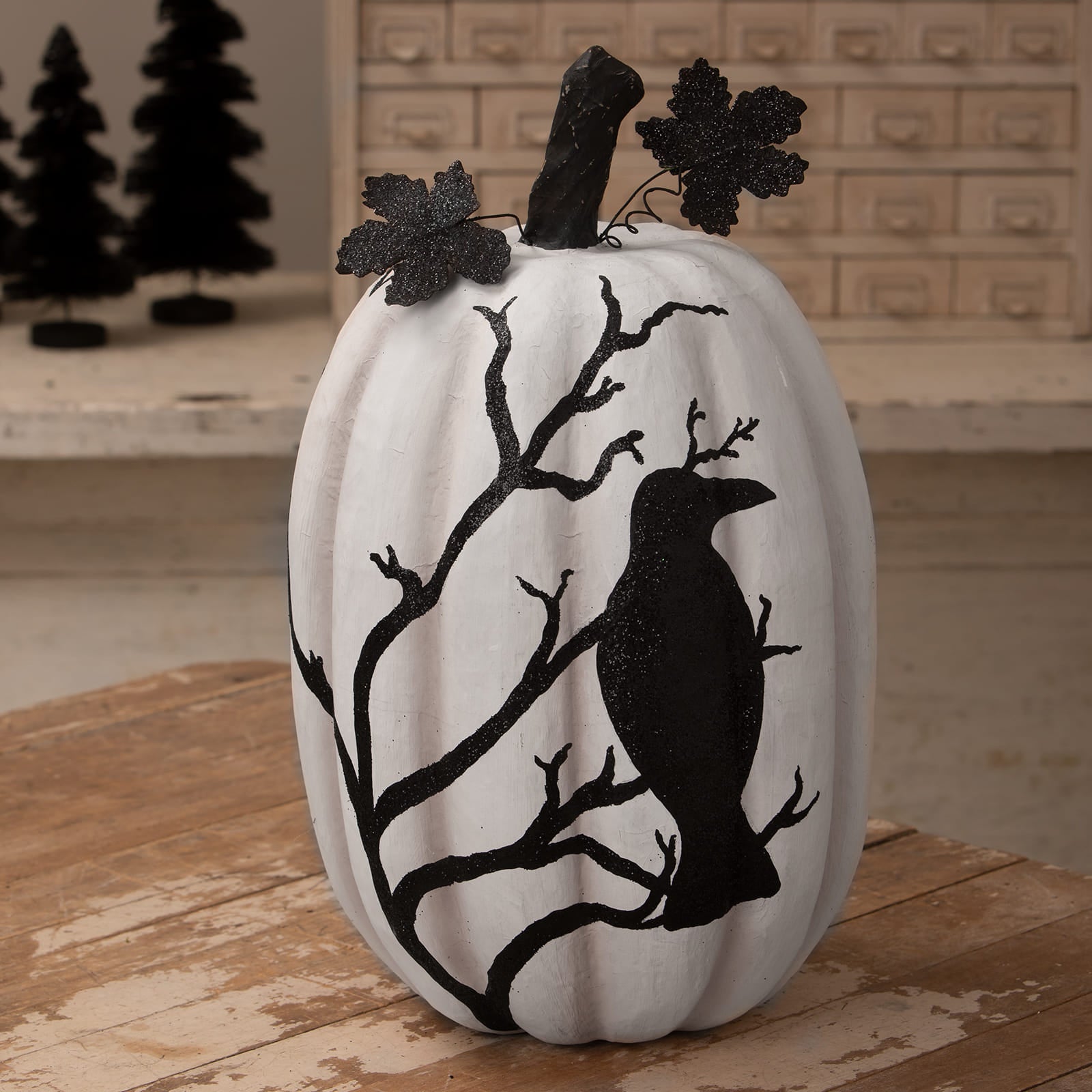 White raven pumpkin decorated with black glittery crow and branch silhouette perfect for halloween pumpkins and gourds