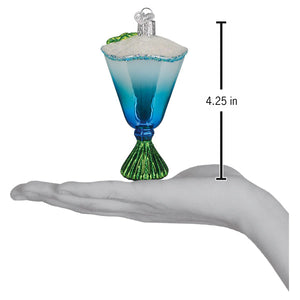Blue glacier cocktail ornament with blue gradient glass, green glitter base, white frosted rim as a christmas glass ornament