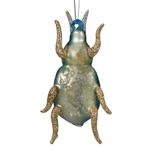 A shimmering glittered beetle ornament with green glittered legs and antennae and a teal silver marbled body