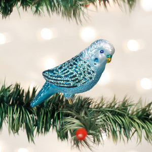 Sparkling blue glass parakeet clip-on ornament perched on pine branch perfect for animal ornaments display