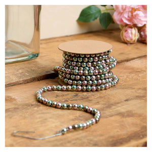 Blue and pink beaded garland spool with iridescent green pink and silver beads perfect for easter and spring garlands