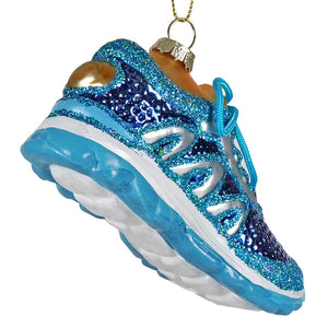 A sparkling blue running shoe ornament with white glitter and gold accents designed as a festive holiday decoration