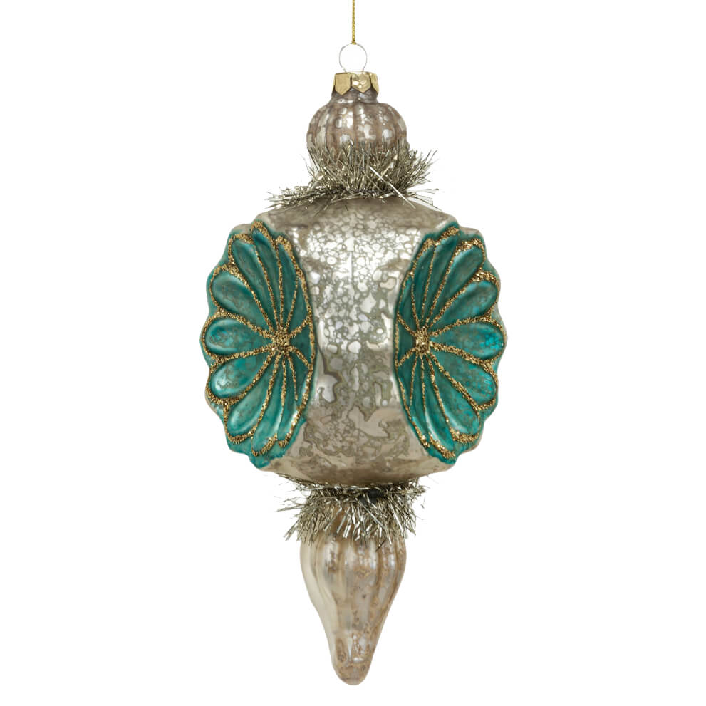 Ornate silver and teal glass Christmas tree ornament with floral designs.