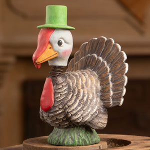 Bobble head turkey by Bethany Lowe featuring a whimsical ceramic gobble gobble turkey with a green top hat