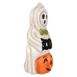 White ceramic halloween ghost figure with black glittery boo text and green bow tie on orange jack o lantern pumpkin