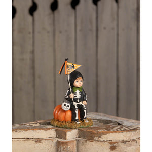 A bethany lowe design boo to you oliver figurine of a child in a skeleton costume with pumpkin and boo flag