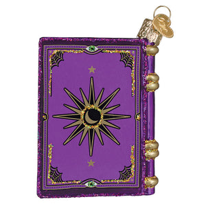 Purple glittery book of spells ornament with gold trim and green gems perfect for figural decor or lighted decor
