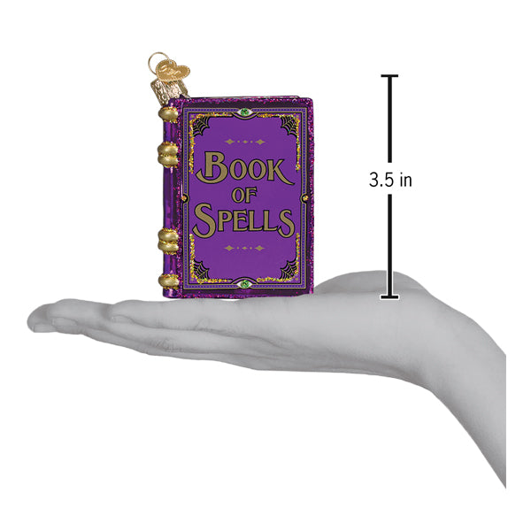 Purple glittery glass book of spells ornament with gold lettering and clasps perfect for figural decor or lighted decor