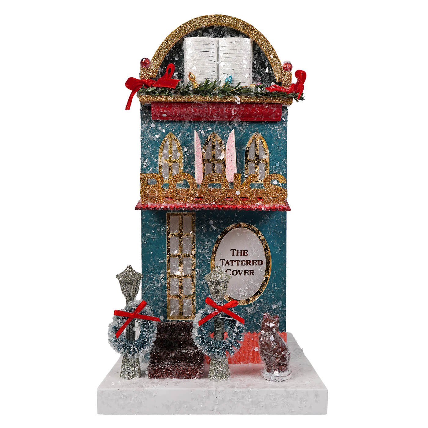 Teal and gold glittery cody foster book shop figurine with snow dusted facade red ribbon and decorative windows light cord