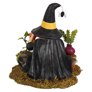 Botany witch black witch figurine with yellow hat band and spider seated on mossy base with miniature plants perfect for halloween witches