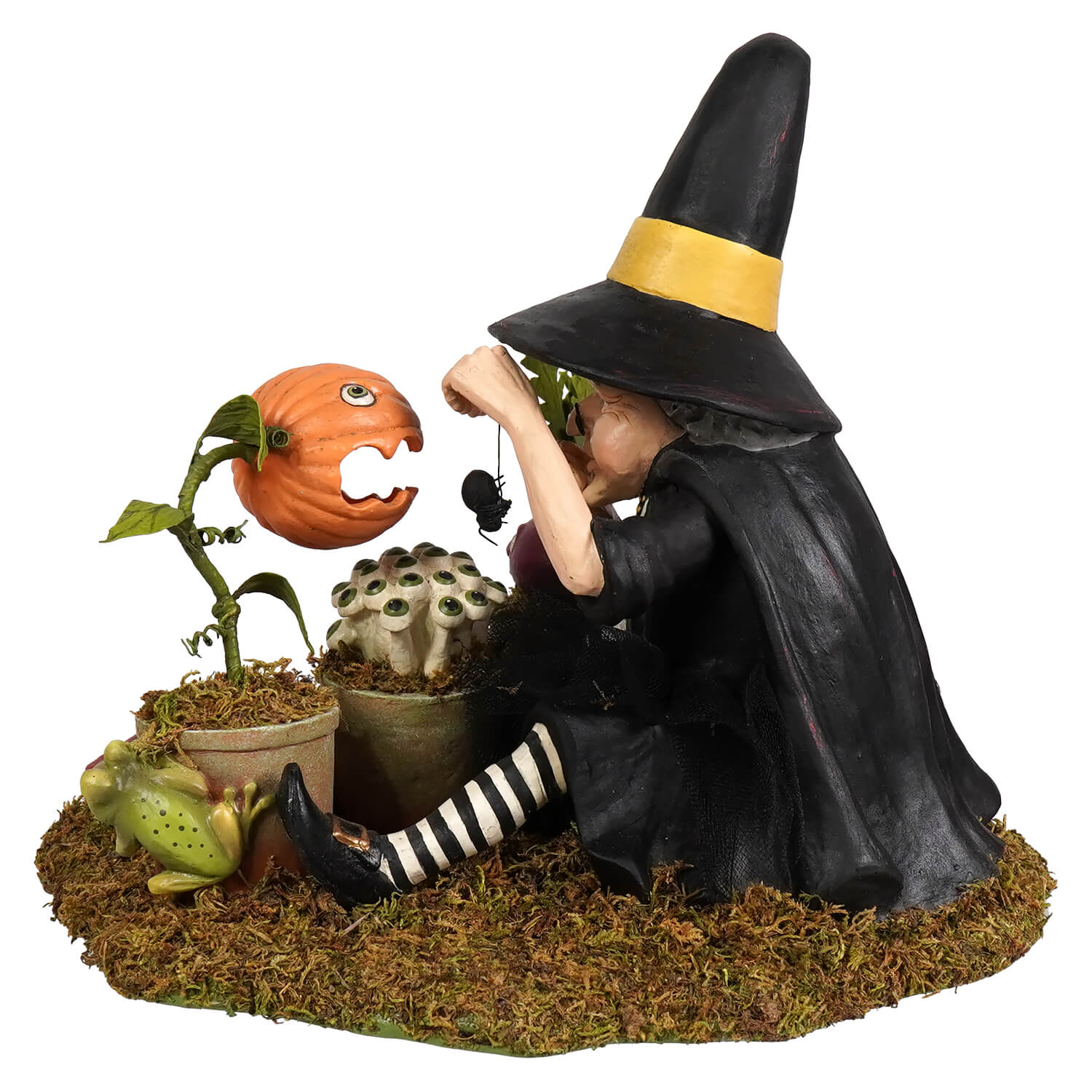 Black botany witch figurine with yellow trim hat and striped stockings seated by whimsical garden elements halloween witches