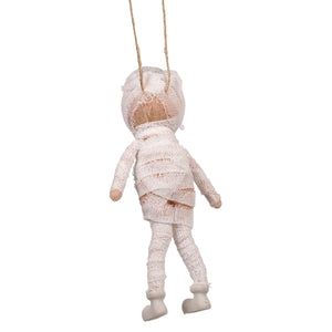 A white felt mummy ornament with bandage-like fabric wrapped over wooden limbs for halloween ornaments