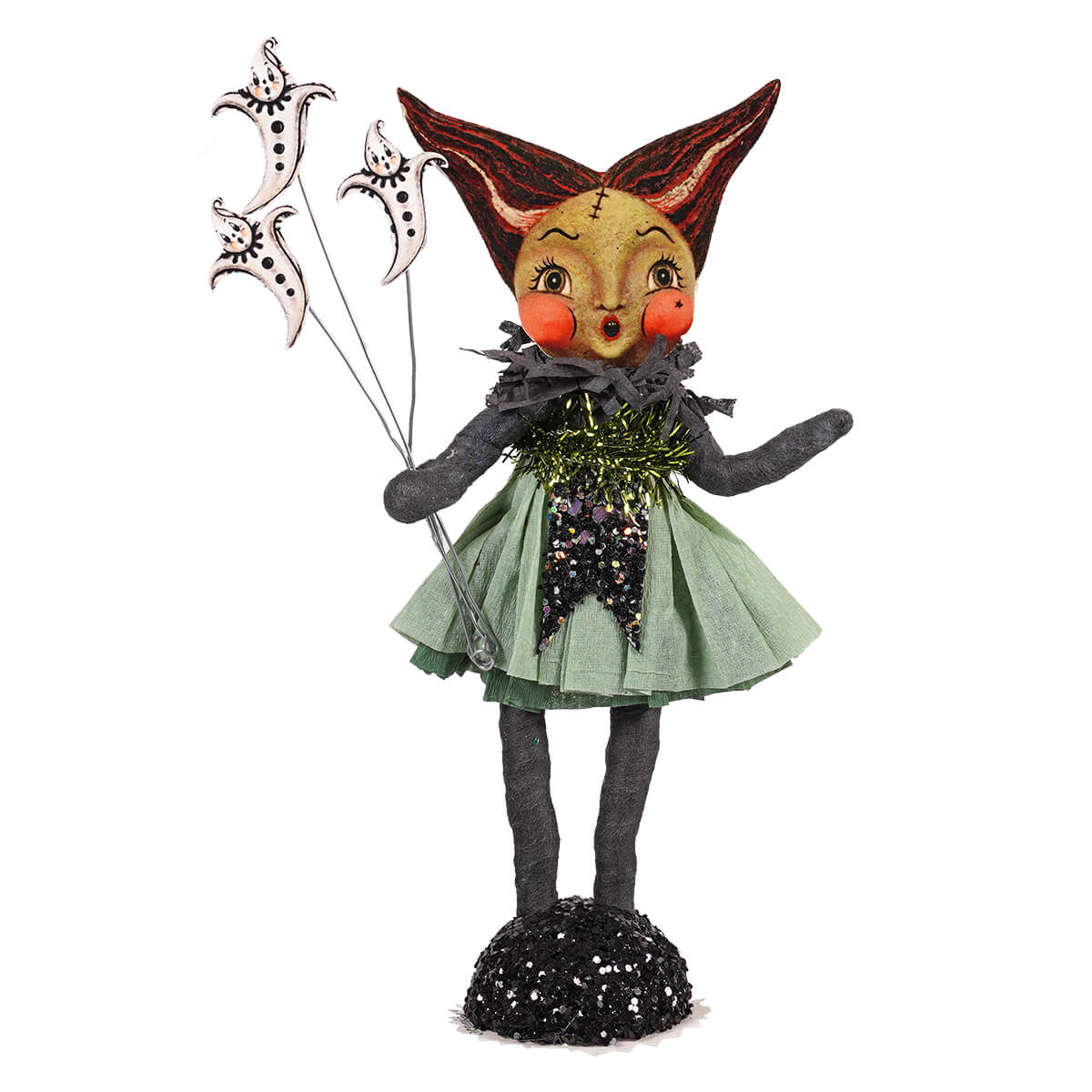 A whimsical bride of frankenstein figurine with red black ears orange cheeks and green sequin dress on glittery base