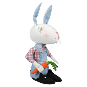 A plush white brixton bunny figurine with light blue ears pink nose in plaid shirt and denim overalls holding carrot by joe spencer