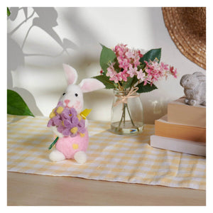A small plush white bunny ornament with pink ears and skirt holding a purple felt bouquet perfect as a sunny bunny gift
