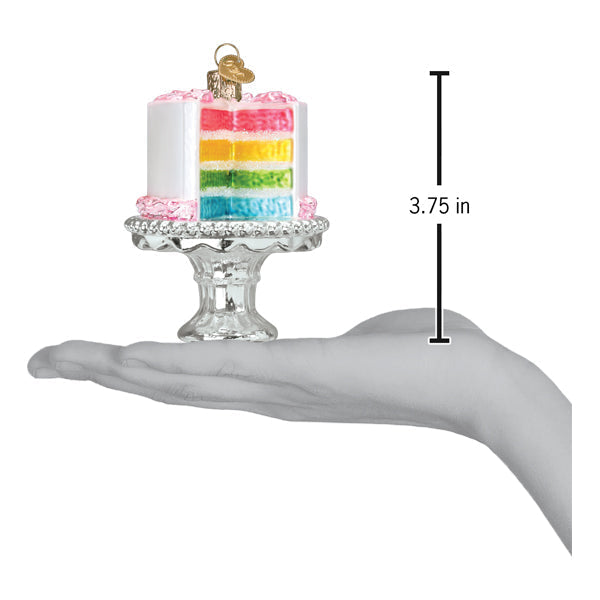Colorful rainbow-layered birthday cake ornament with pink frosting and gold topper on clear glass stand food & drink ornament
