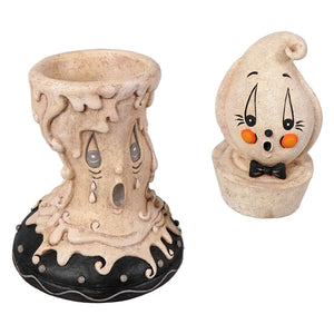 Cream-colored resin candlestick with melting design and black base perfect for johanna parker halloween decor