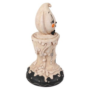 A whimsical beige ghost candlestick with black eyes orange nose and bow tie on a melting base johanna parker halloween decor