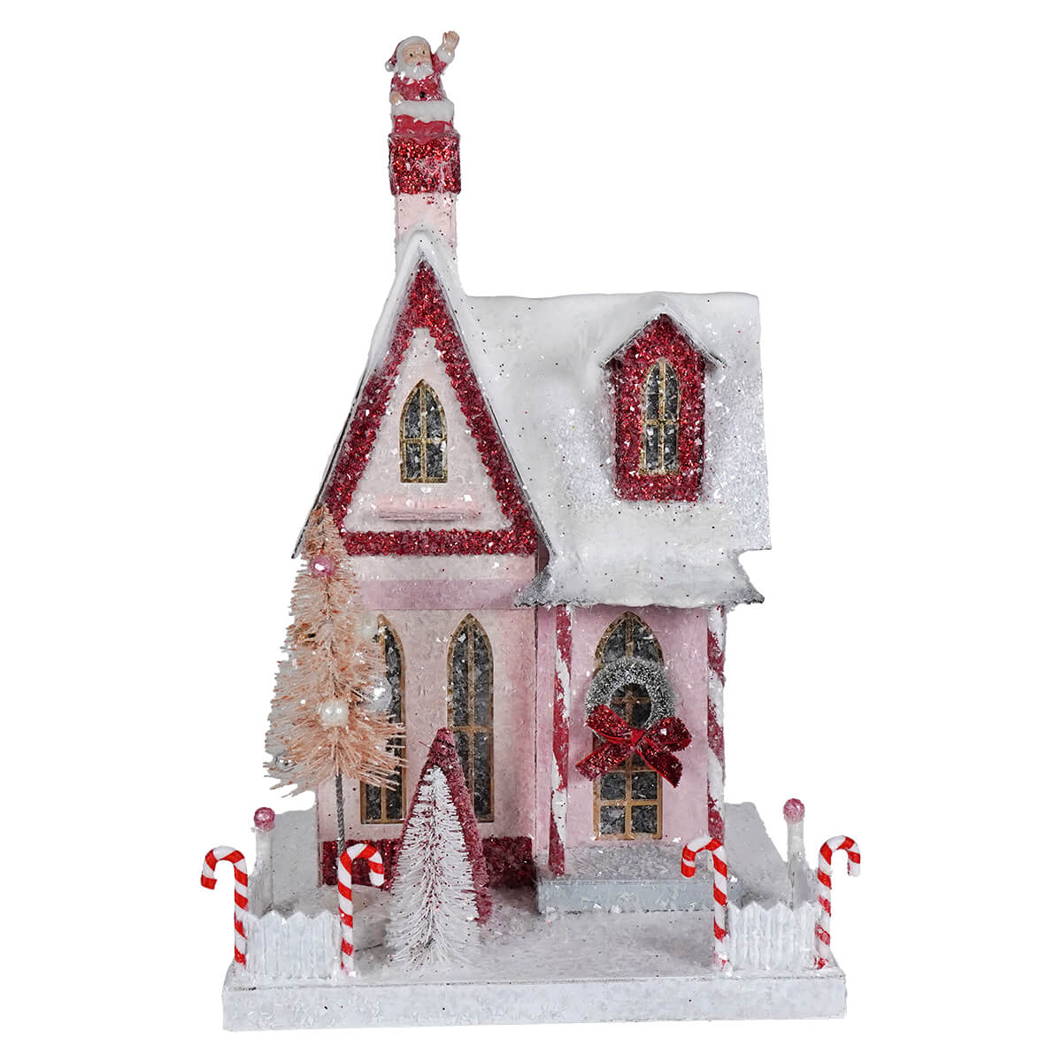 A festive pink candy cane cottage house figurine with glittery red trim and santa spreading holiday cheer