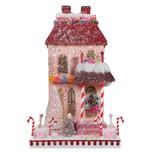 A sparkling pink candy cane manor candy house ornament with glittery red roof and festive striped candy canes by cody foster