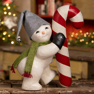 A charming white christmas snowman figure with a glittery silver hat green scarf holding a candy cane decor piece