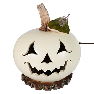 Cream-colored lighted jack-o-lantern gourd with carved face rustic wooden stem and leaf on tree-stump base by meadowbrooke gourds artisans