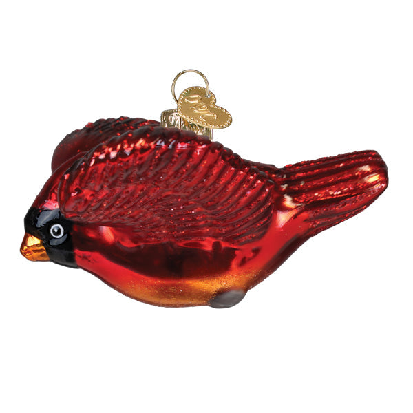 A glossy red glass cardinal ornament with black and orange accents and a gold heart tag perfect as figural decor